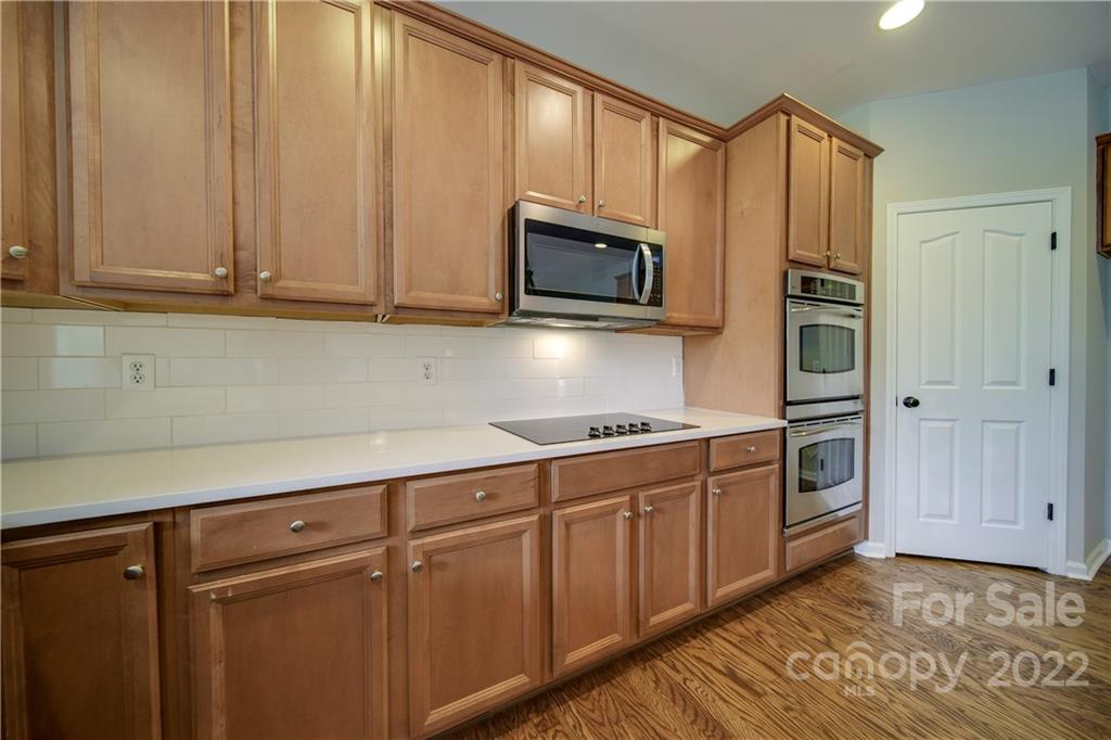 2751 Rivendale Court Indian Land, SC 29707 - Photo 14 of 48 a kitchen with stainless steel appliances granite countertop a refrigerator a stove and a sink with wooden cabinets