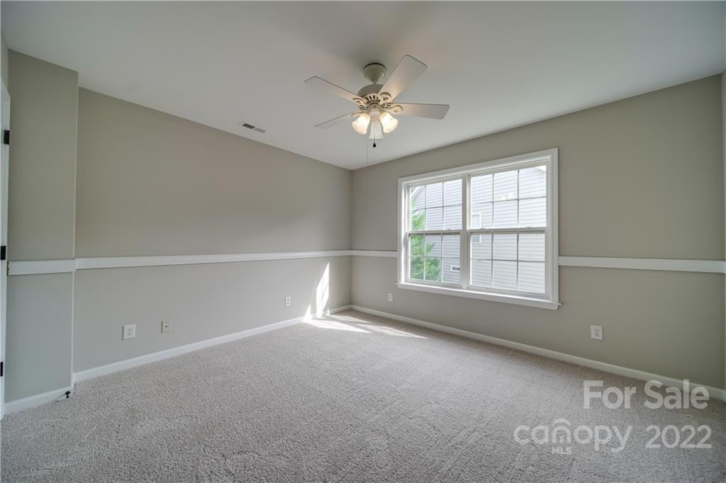 2751 Rivendale Court Indian Land, SC 29707 - Photo 35 of 48 an empty room with chandelier fan and windows