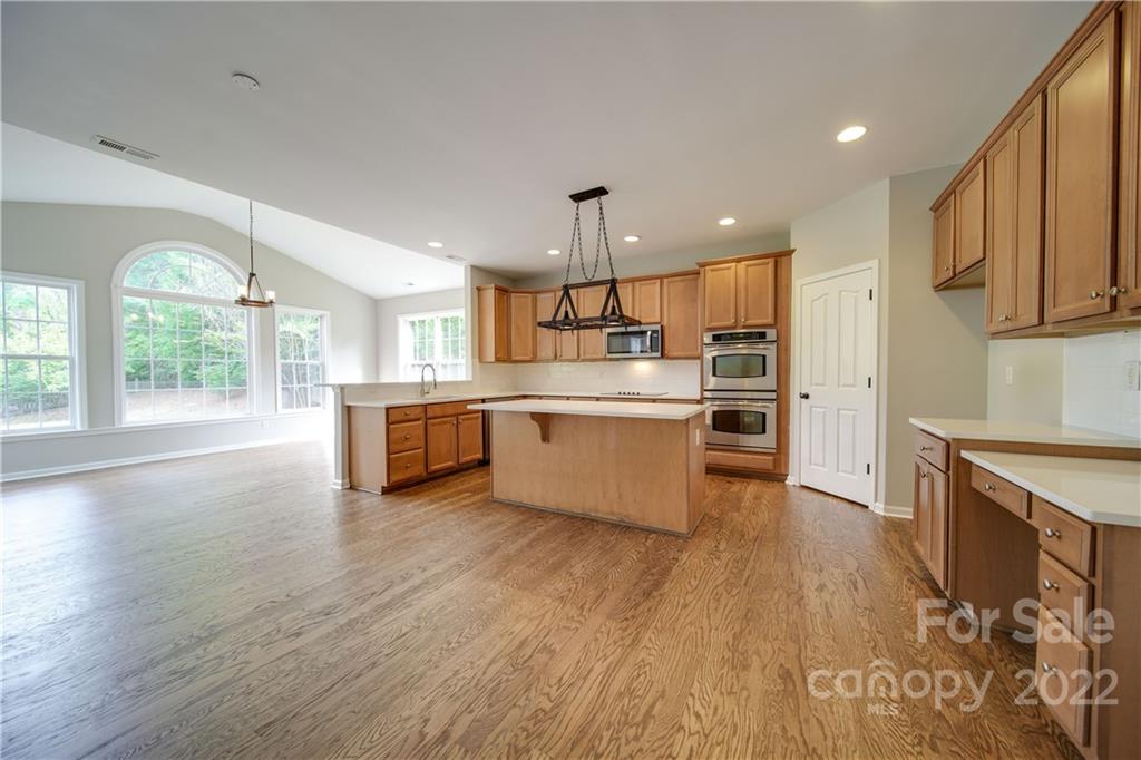 2751 Rivendale Court Indian Land, SC 29707 - Photo 10 of 48 a large kitchen with stainless steel appliances granite countertop a lot of counter space and wooden floors
