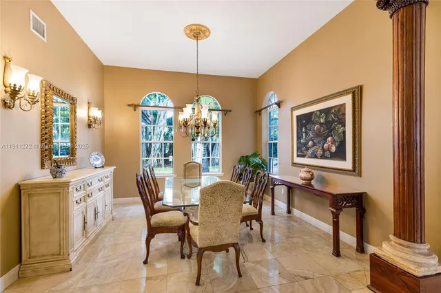 a living room with furniture a chandelier and a fireplace