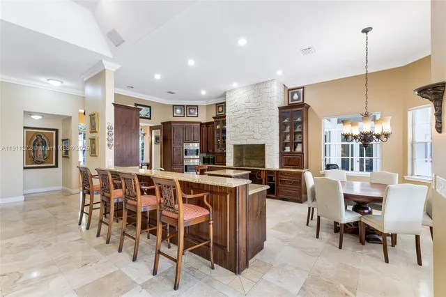 a large kitchen with stainless steel appliances granite countertop a sink and cabinets