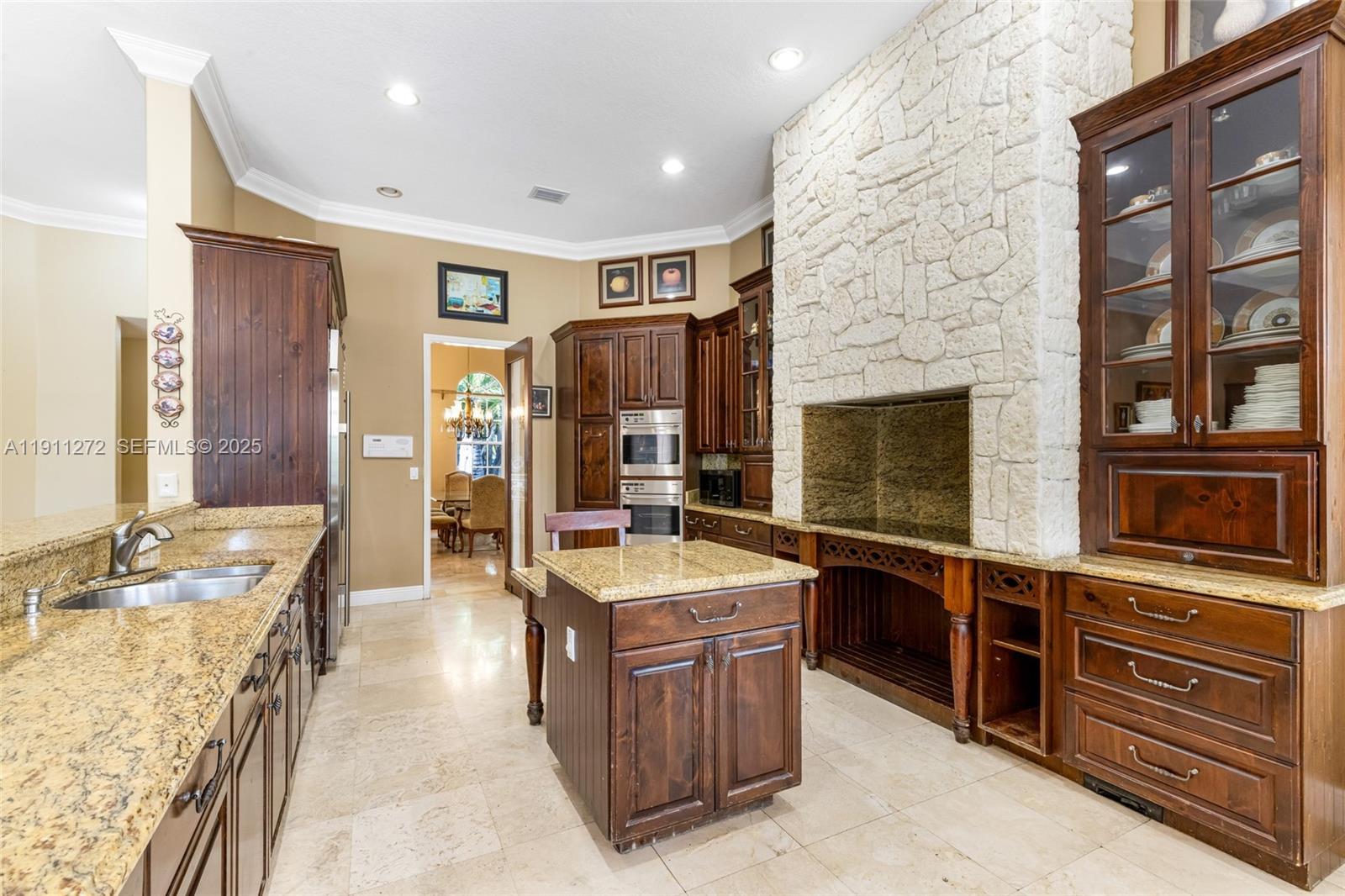 7250 Southwest 99th Street Pinecrest, FL 33156 - Photo 15 of 40 a large kitchen with stainless steel appliances granite countertop a sink and cabinets