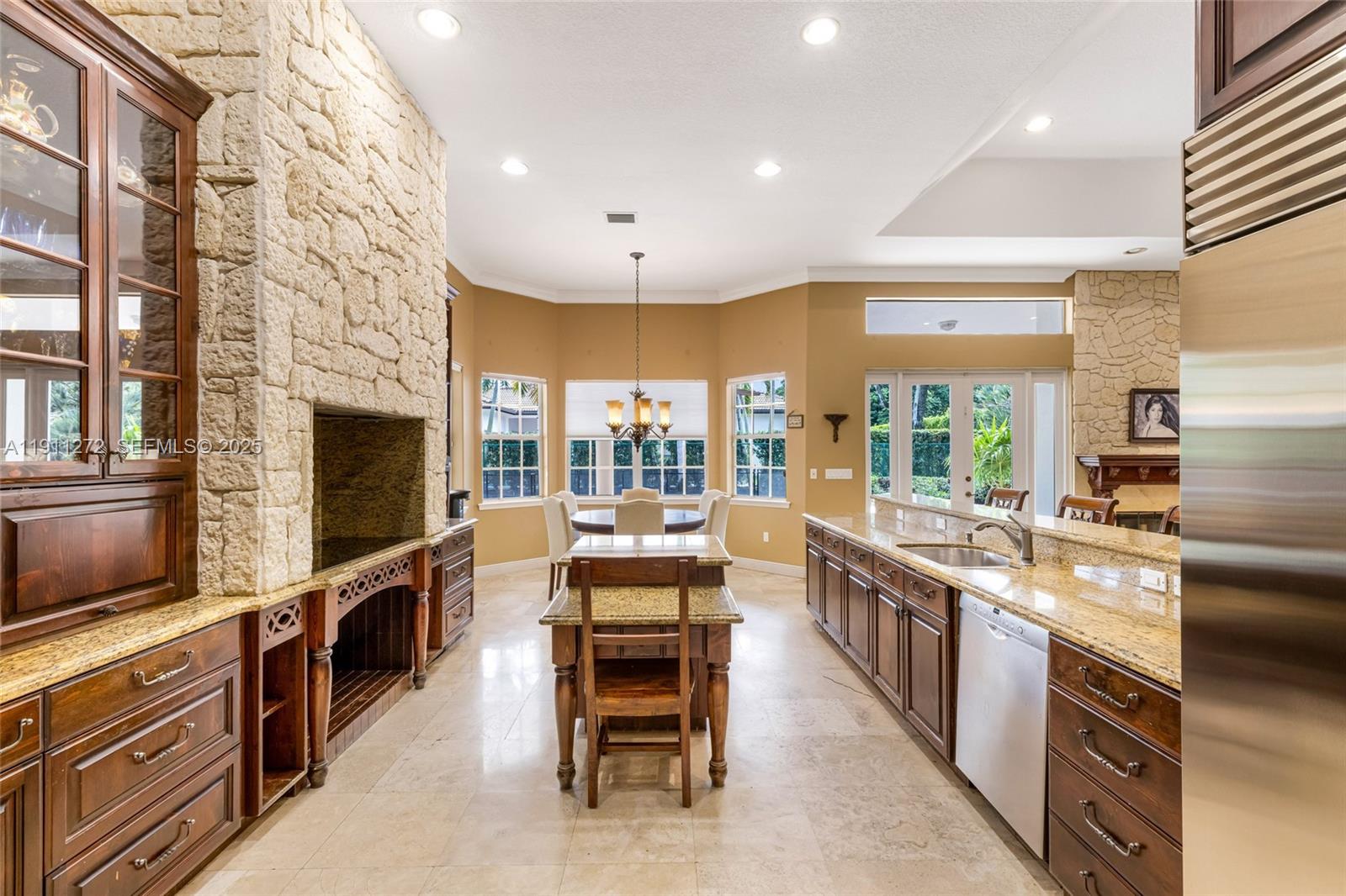 7250 Southwest 99th Street Pinecrest, FL 33156 - Photo 16 of 40 a large kitchen with stainless steel appliances and large windows