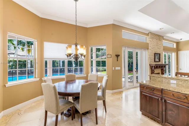 a living room with furniture kitchen view and a chandelier