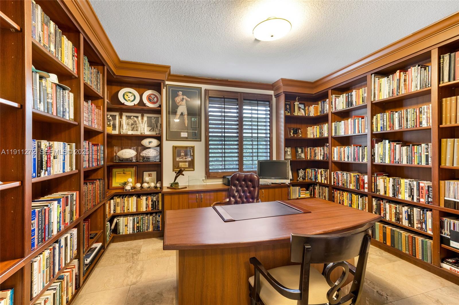 7250 Southwest 99th Street Pinecrest, FL 33156 - Photo 20 of 40 a dining room with furniture and a book shelf