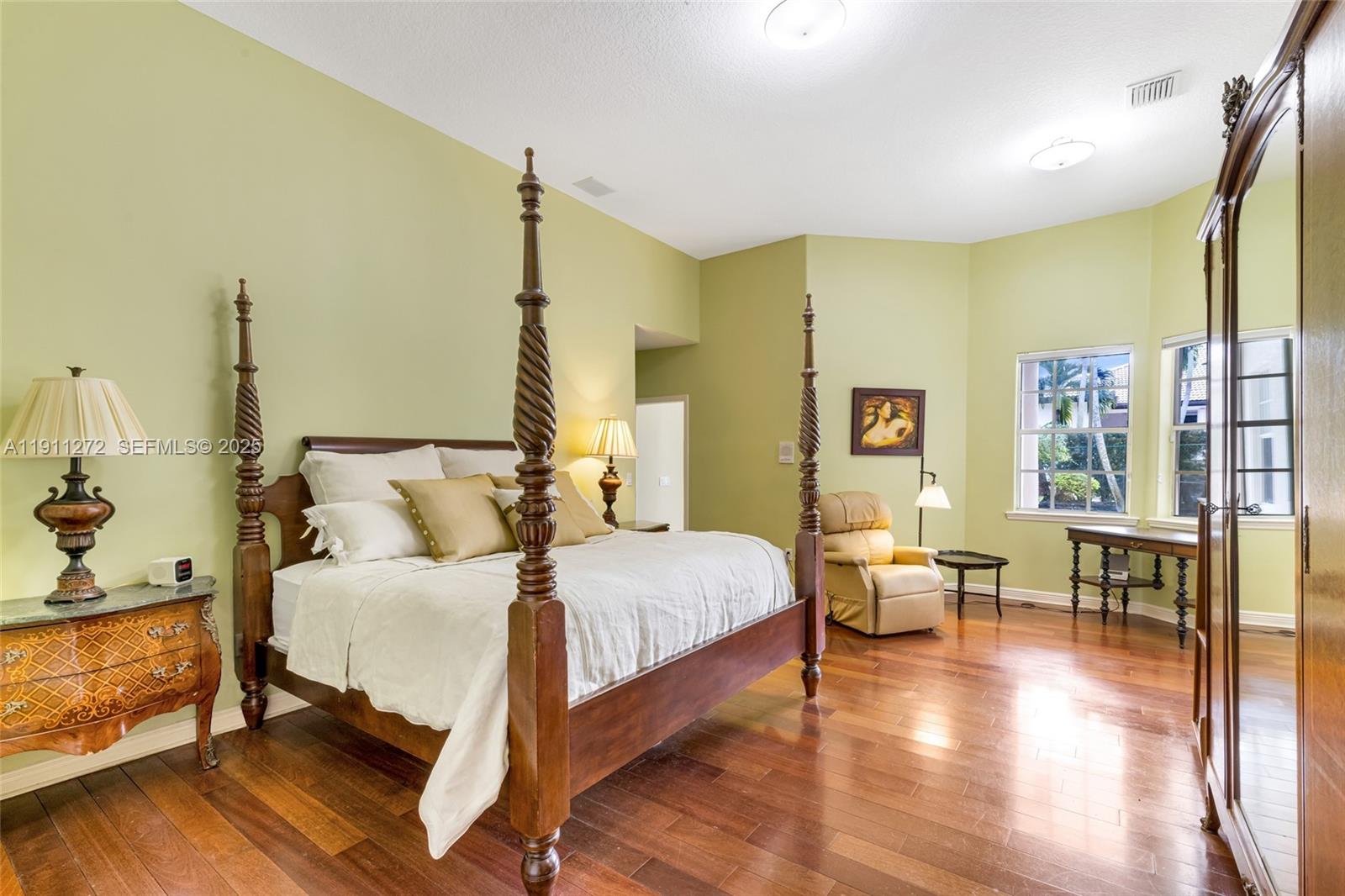 7250 Southwest 99th Street Pinecrest, FL 33156 - Photo 21 of 40 a bedroom with a bed and wooden floor