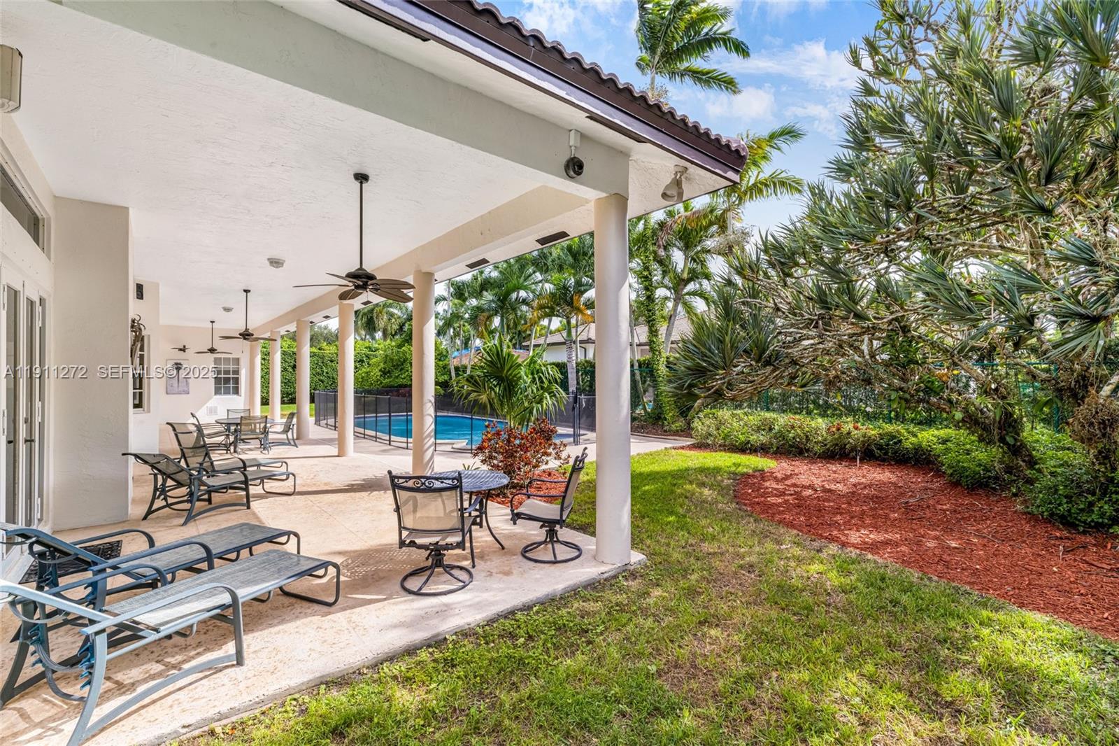 7250 Southwest 99th Street Pinecrest, FL 33156 - Photo 29 of 40 a view of a backyard with couches plants and large trees