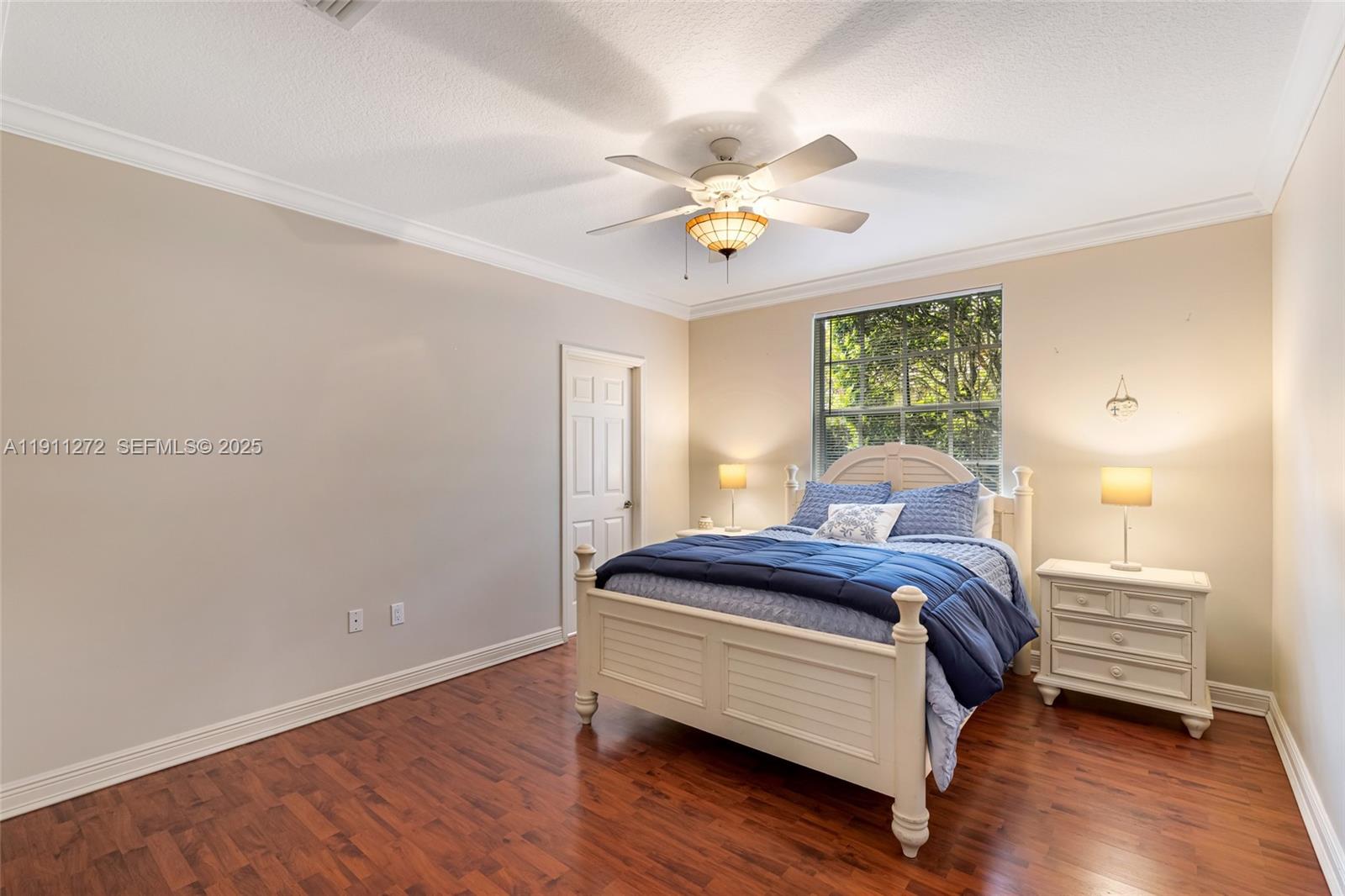 7250 Southwest 99th Street Pinecrest, FL 33156 - Photo 31 of 40 a bedroom with a bed and wooden floor