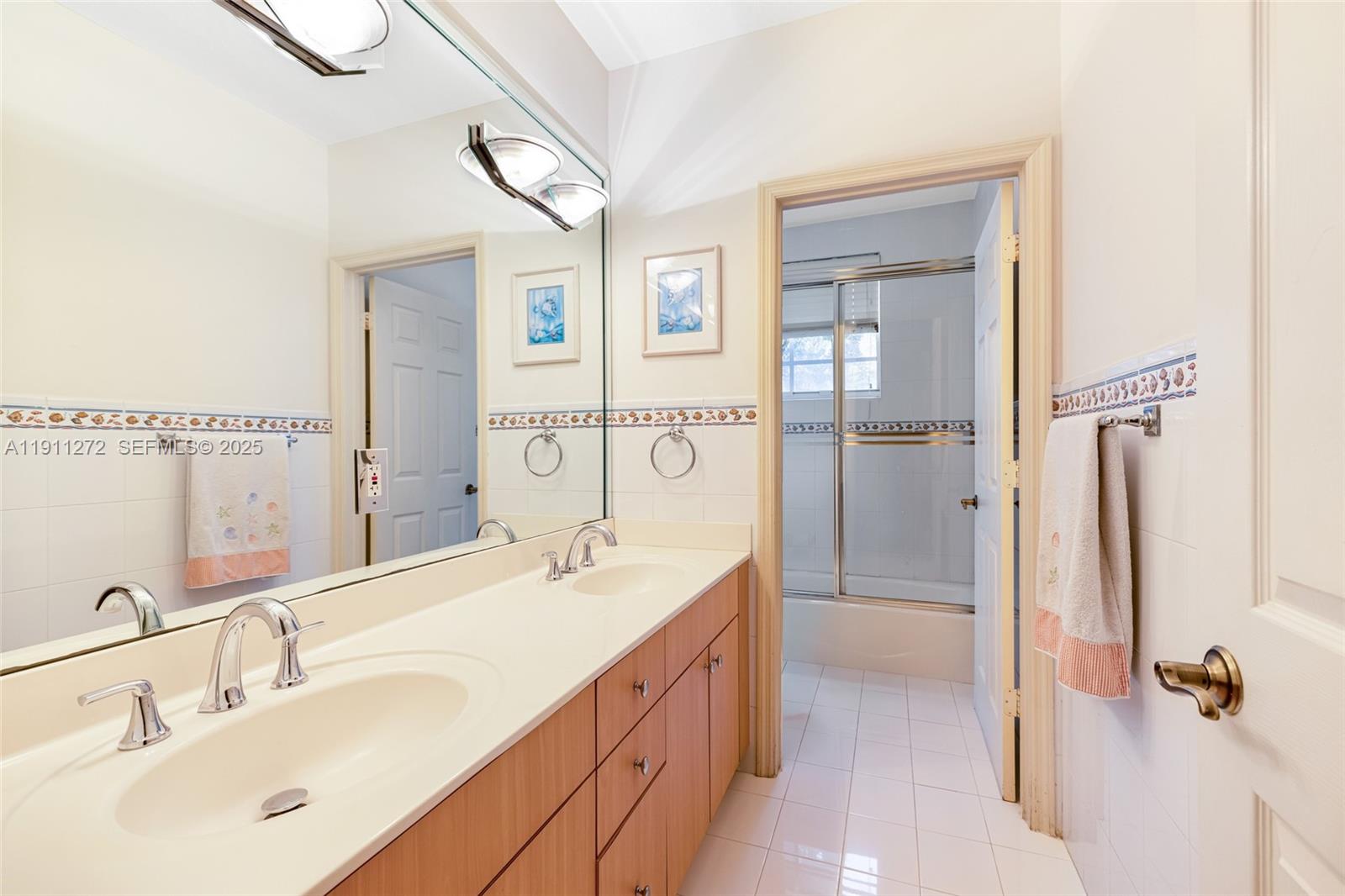 7250 Southwest 99th Street Pinecrest, FL 33156 - Photo 34 of 40 a spacious bathroom with a double vanity sink a mirror and shower