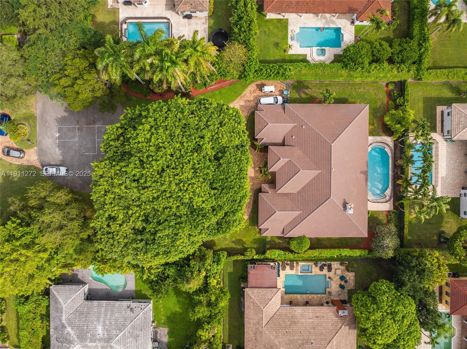 7250 Southwest 99th Street Pinecrest, FL 33156 - Photo 35 of 40 an aerial view of a house with a yard and lake view