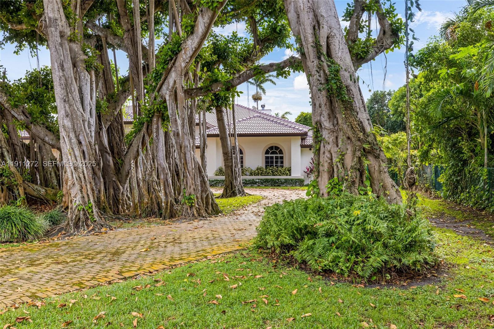 7250 Southwest 99th Street Pinecrest, FL 33156 - Photo 6 of 40 a view of backyard of house with green space