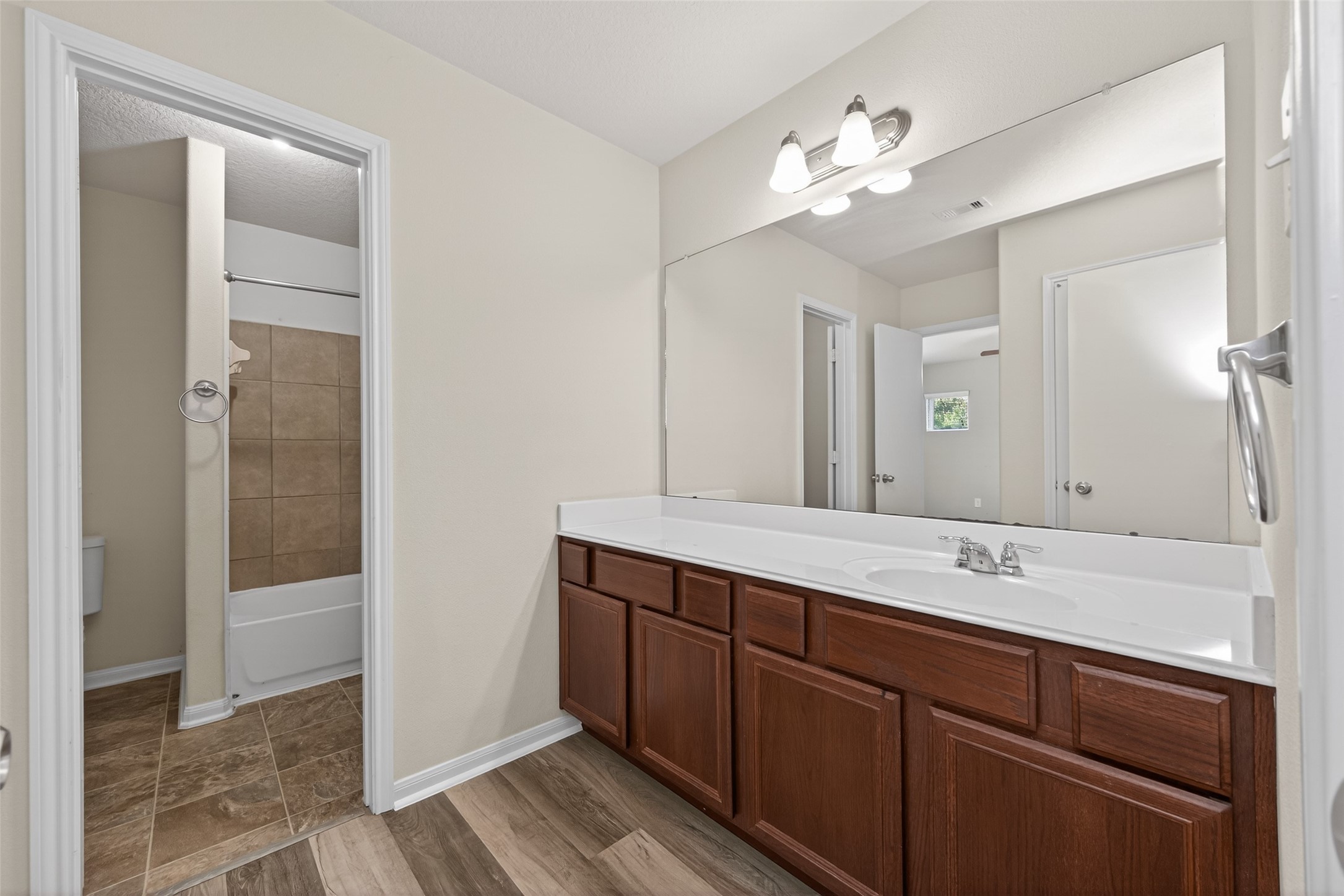 9940 Swallow Drive Conroe, TX 77385 - Photo 19 of 30 Jr. Primary Bathroom. Two doors, one to bathroom and one to hallway.