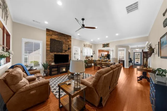 a living room with furniture a chandelier and a large window