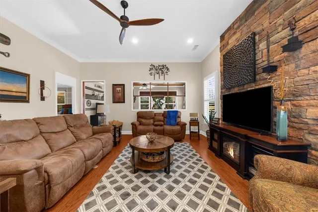 a living room with furniture a fireplace and a large window