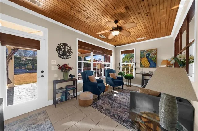 a living room with patio furniture and a floor to ceiling window