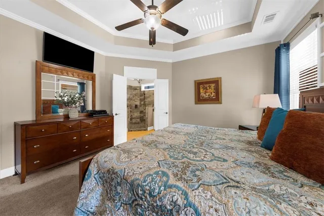 an aerial view of a house with a garden and lake view