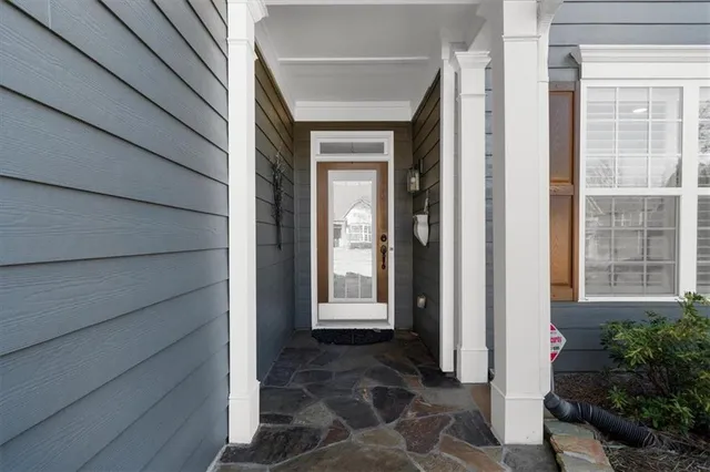 a kitchen with stainless steel appliances granite countertop a stove top oven a sink dishwasher a dining table and chairs with wooden floor