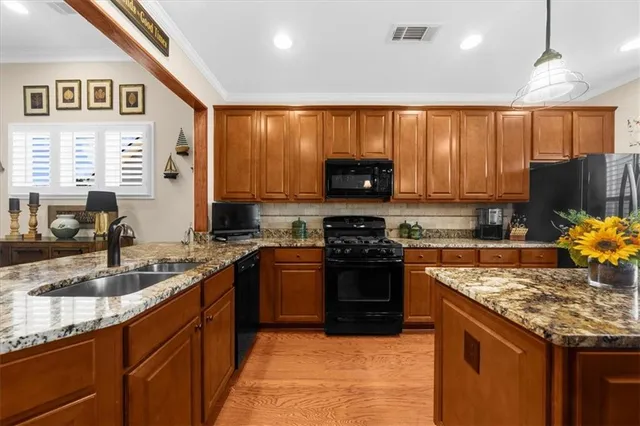 a living room with furniture kitchen view and a large window