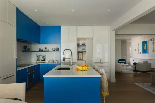 a kitchen with a sink a stove and cabinets