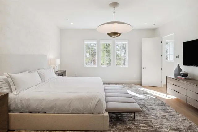 a bedroom with a bed and a flat screen tv