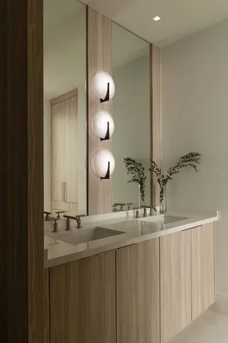 a bathroom with a double vanity sink and a mirror