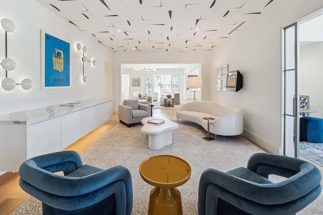 a living room with furniture and a painting