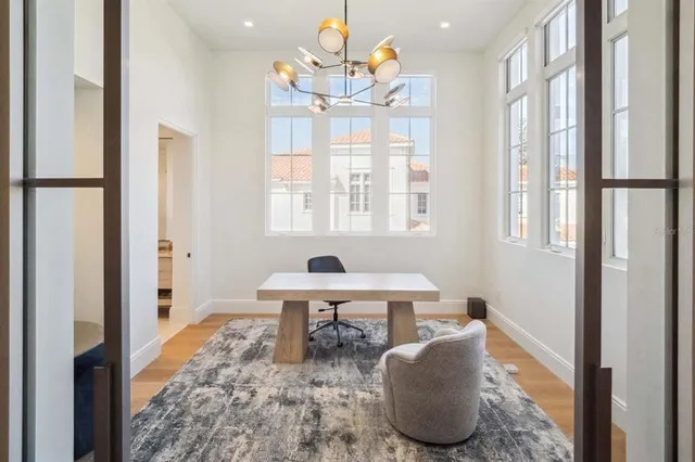 a living room with table chairs and a window