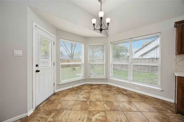 a spacious bathroom with a granite countertop sink and a mirror
