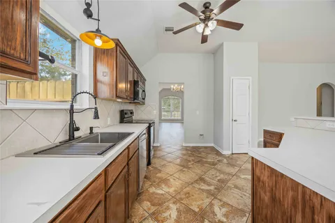 a kitchen with sink cabinets and window