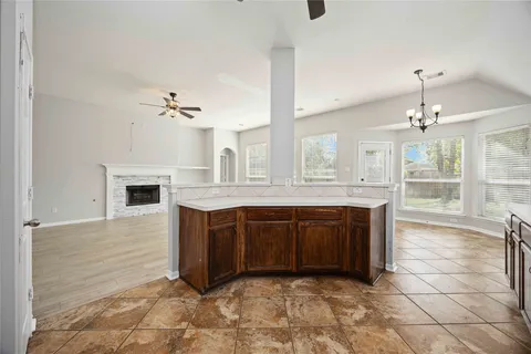 a spacious bathroom with a granite countertop sink mirror and bathtub