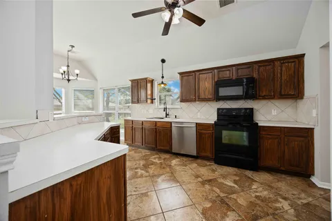 a kitchen with a sink stove and microwave