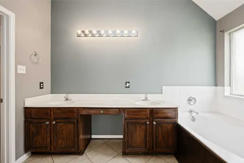 a spacious bathroom with a granite countertop sink and a mirror