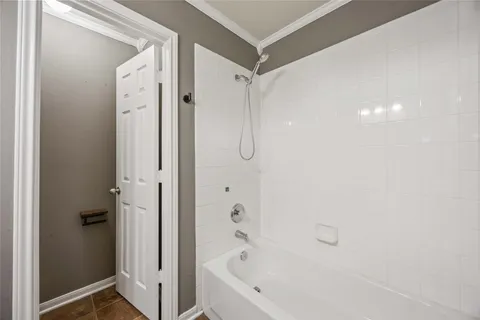 a bathroom with a bathtub shower and a sink