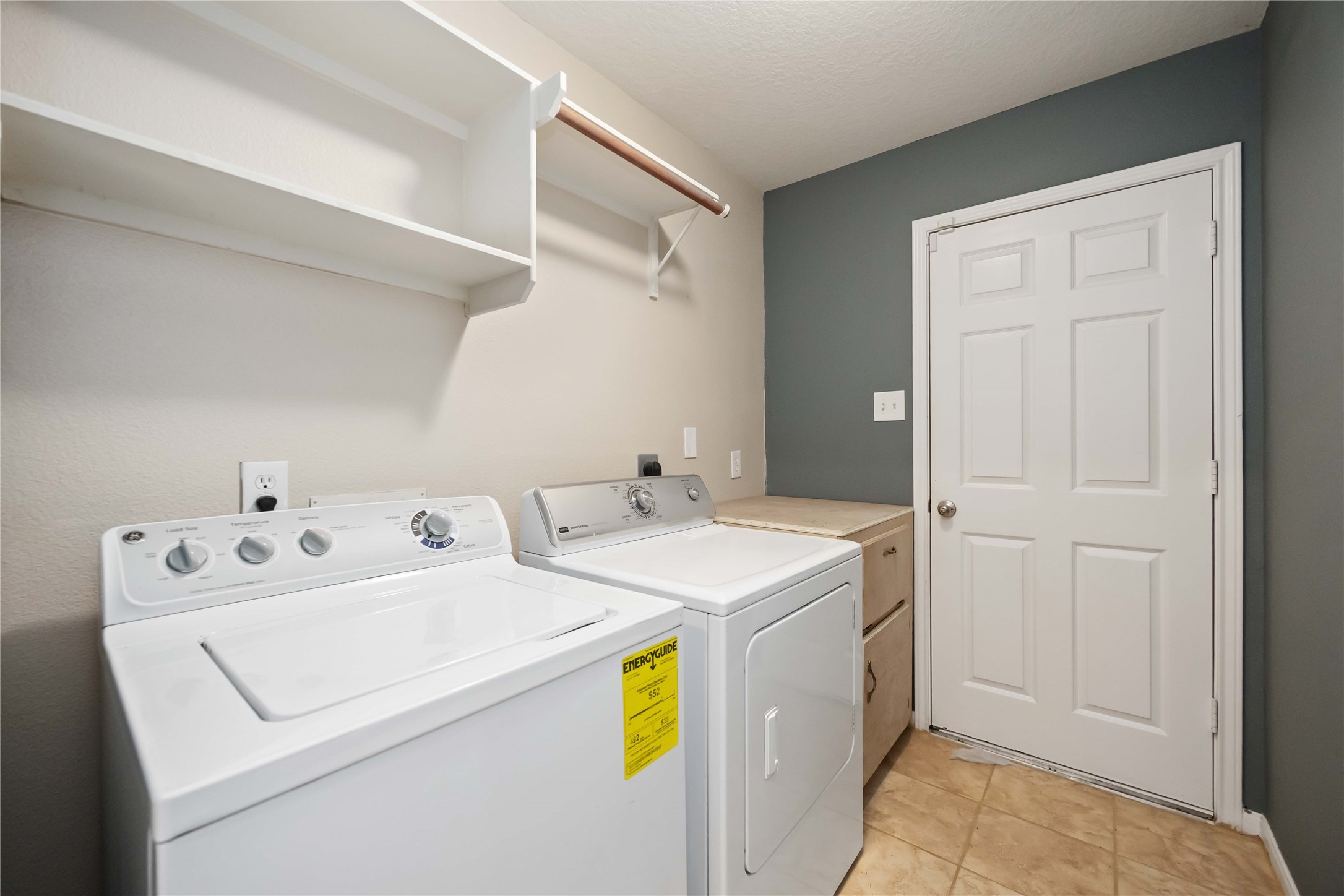 17102 Jetty Court Crosby, TX 77532 - Photo 33 of 39 Laundry room featuring a washer and dryer set, shelving for storage.