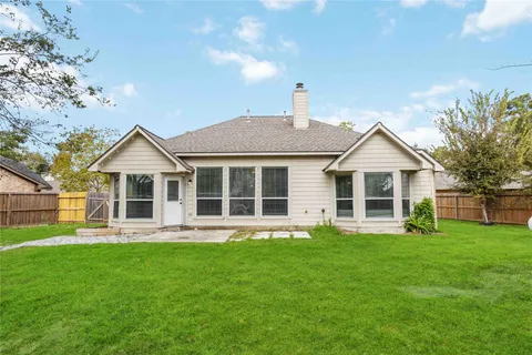 a front view of a house with a yard and trees