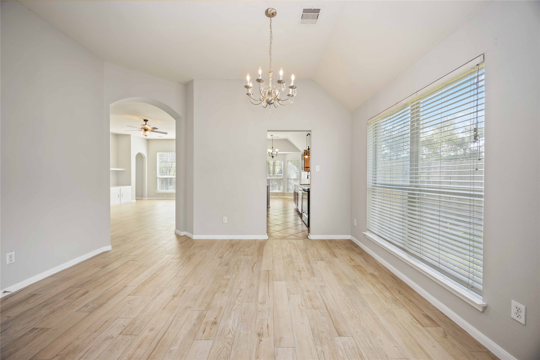 17102 Jetty Court Crosby, TX 77532 - Photo 7 of 39 Open dining area with light wood flooring and a modern chandelier.