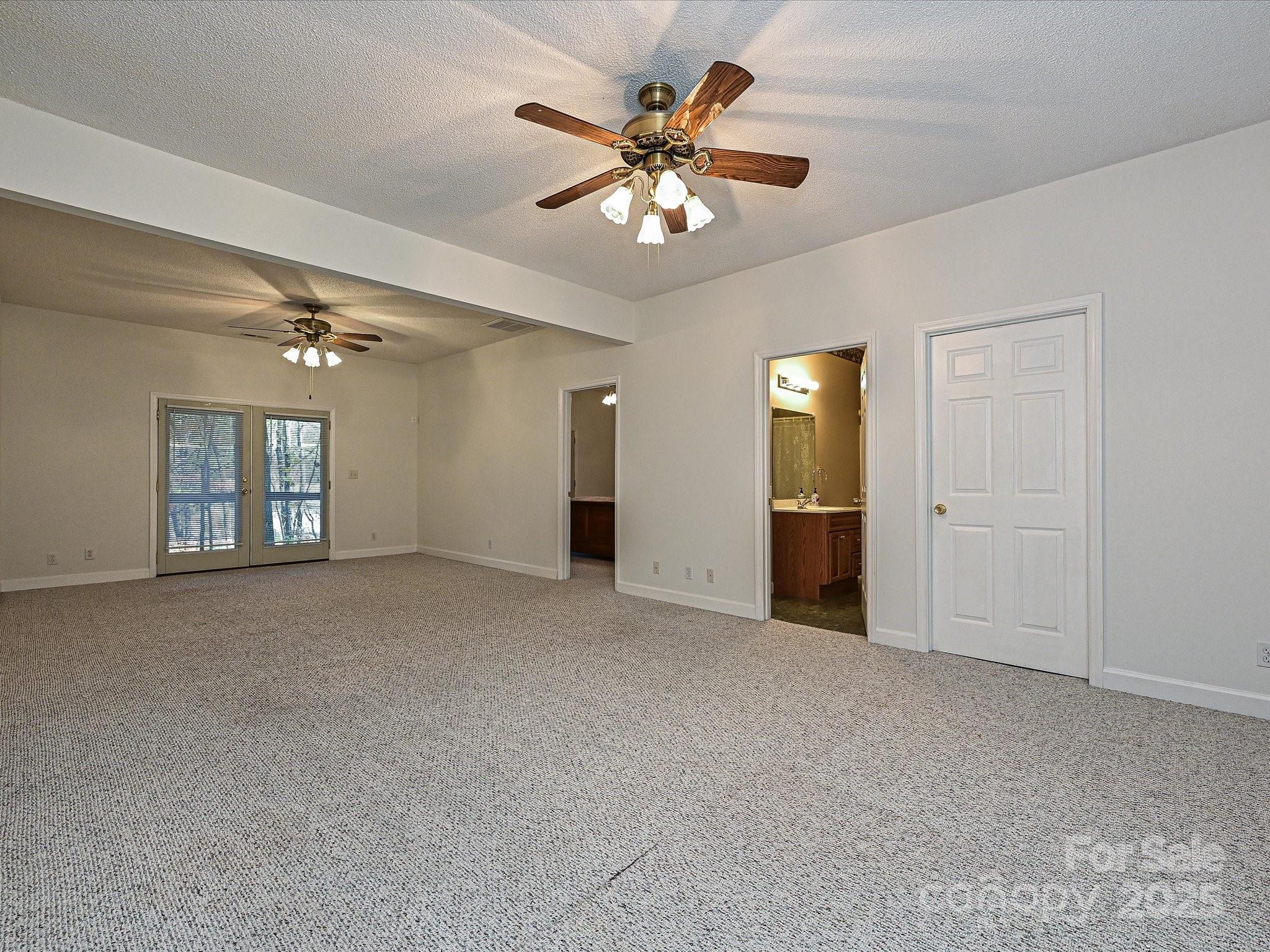 25040 Timberlake Drive Tega Cay, SC 29708 - Photo 30 of 40 a view of an empty room with a ceiling fan and a window