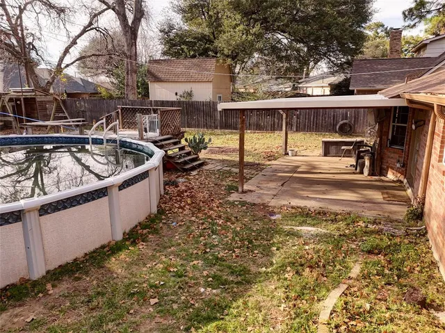 a view of a backyard with a large tree