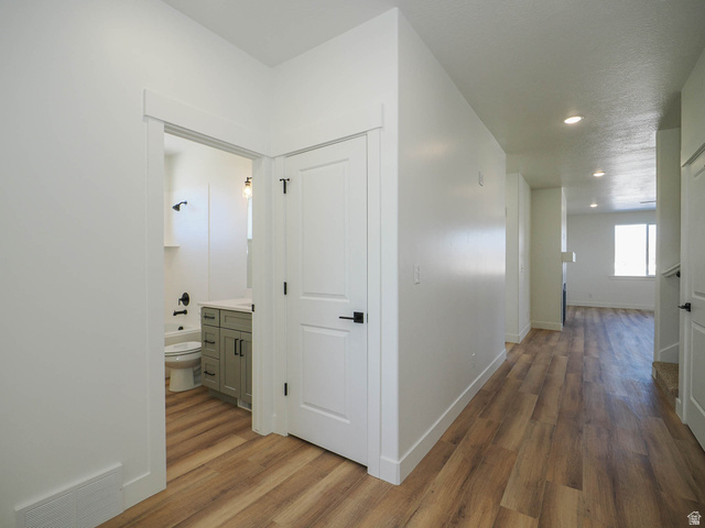 3938 North Wood Road Eagle Mountain, UT 84005 - Photo 7 of 55 Hall featuring dark wood-type flooring and recessed lighting