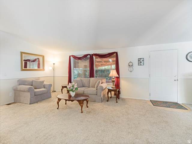 3941 West 40 North Hurricane, UT 84737 - Photo 8 of 55 Carpeted living area featuring a two-tone wall treatment with chair rail molding and a paneled entry door