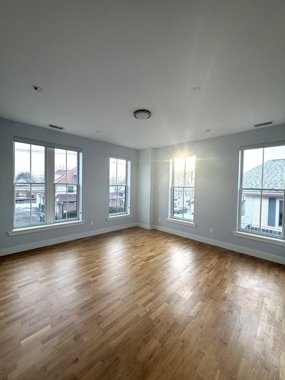 13 West Central Street, Unit 2 Natick, MA 01760 - Photo 3 of 14 a view of empty room with wooden floor and fan