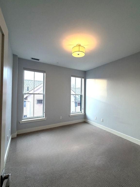 13 West Central Street, Unit 2 Natick, MA 01760 - Photo 4 of 14 an empty room with a window