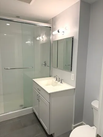 a bathroom with a sink toilet and shower