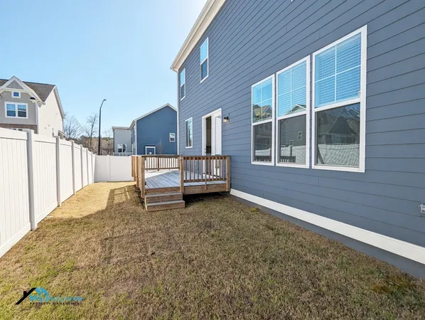 a view of a house with a wooden fence