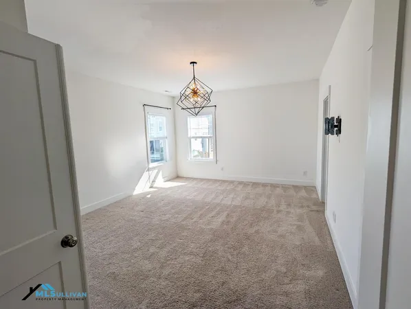 an empty room with windows and closet