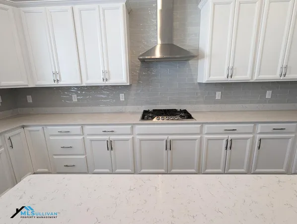 a kitchen with white cabinets
