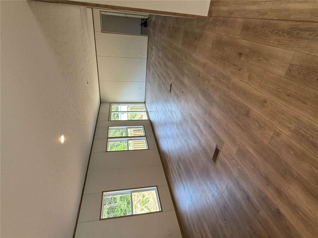 1052 Jones Ferry Road Elberton, GA 30635 - Photo 6 of 16 an empty room with wooden floor and windows