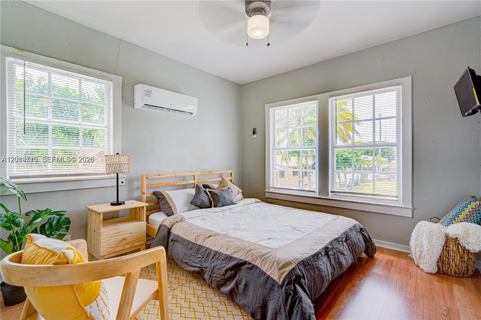 227 Southwest 30th Avenue, Unit B Miami, FL 33135 - Photo 10 of 15 a bedroom with a bed and windows