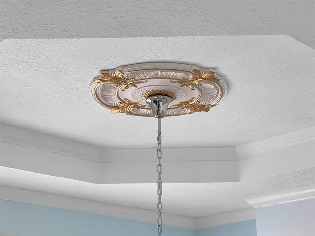a kitchen with a sink dishwasher stove and white cabinets next to a window
