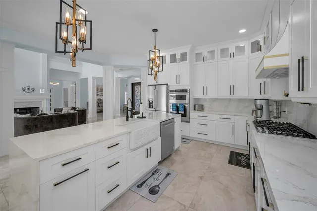 a living room with furniture a window and a chandelier